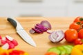 Closeup on onion and knife on cutting board Royalty Free Stock Photo