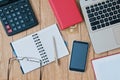 Closeup open notebook, laptop, calculator, pen, smartphone on a Royalty Free Stock Photo