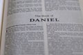 Closeup of an open page of the book of daniel with partly blurred text Royalty Free Stock Photo