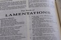 Closeup of an open page of the book of lamentations with partly blurred text Royalty Free Stock Photo