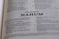 Closeup of an open page of the book of nahum with partly blurred text Royalty Free Stock Photo