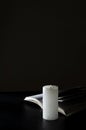 Vertical image of opened Bible and candle on the dark surface against black background.Empty space Royalty Free Stock Photo