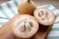 Closeup of Opened Fresh Cotton Fruit or Santol Fruit with Whole Fruit in Background