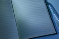 Closeup of opened notebook at night, blue toned image, blank for text Royalty Free Stock Photo