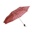 Closeup on an opened red checkered umbrella with a black ending on a white background