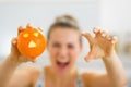 Closeup on orange with hallowing face in hand of woman Royalty Free Stock Photo