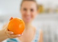 Closeup on orange in hand of young woman Royalty Free Stock Photo