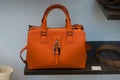 orange leather hand bag in a fashion store showroom