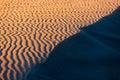 orange nature texture of the sand and dunes rippled surface, top angle view. Desert background. Play of light and shadow Royalty Free Stock Photo