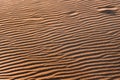 Orange nature texture of the sand and dunes rippled surface, top angle view. Desert background. Play of light and shadow Royalty Free Stock Photo