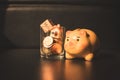 Closeup orange piggy bank with stack coins