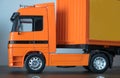 Closeup an orange trailer truck souvenir.