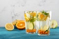 Closeup orange water with sea buckthorn and mint in glasses on blue background, summmer drink concept Royalty Free Stock Photo