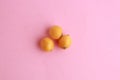 Closeup of oranges on a pink-colored background Royalty Free Stock Photo