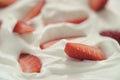 Closeup of organic sliced strawberries in whipped cream Royalty Free Stock Photo