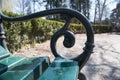 Closeup ornate black railing vintage park bench Royalty Free Stock Photo