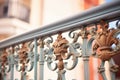 closeup of ornate wroughtiron balcony railings on mediterranean facade