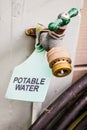 Closeup of outdoor faucet with potable water tag Royalty Free Stock Photo