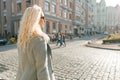 Closeup outdoor portrait of young smiling blond woman with sunglasses with long curly hair. On city street sunny day Royalty Free Stock Photo