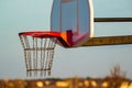 Closeup of an outdoors basketball hoop at sunrise