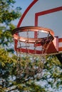 A closeup of an outdoors basketball hoop at sunrise