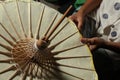 Closeup overhead shot of a person making a traditional Thai paper umbrella Royalty Free Stock Photo