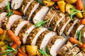 Closeup Overhead View of Roast Pork Tenderloin with Potatoes and Baby Carrots Royalty Free Stock Photo