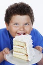 Closeup Of An Overweight Boy Holding Large Slice Of Cake