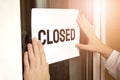 Closeup of owner holding closed sign in store Royalty Free Stock Photo