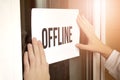 Closeup of owner holding text OFFLINE in store Royalty Free Stock Photo