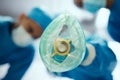 Closeup oxygen mask, ventilation and doctors in hospital of emergency healthcare, surgery or medicine in operating room Royalty Free Stock Photo