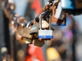 Closeup of a padlock hanging on chain link of the bridge / Fence Royalty Free Stock Photo