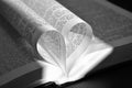 Closeup pages of an open book, with heart shaped pages Royalty Free Stock Photo