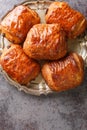 Closeup of a pain au chocolat or napolitana croissant filled with chocolate on the plate. Vertical top view Royalty Free Stock Photo