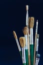 Closeup of paint brushes isolated on blue background Royalty Free Stock Photo