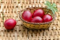 Closeup paint Easter red eggs in the basket on wicker table