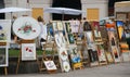 Closeup of paintings on the display for sale in a park in Nice, France