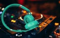 Closeup pair of aqua blue emerald green headphones for DJ.cd mp4 music deejay mixing desk music party in nightclub. Club console Royalty Free Stock Photo