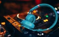 Closeup pair of aqua blue emerald green headphones for DJ.cd mp4 music deejay mixing desk music party in nightclub. Club console Royalty Free Stock Photo