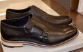 Closeup of a pair of black monk shoes on the shelf at a store