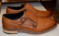 Closeup of a pair of brown monk shoes on the shelf at a store
