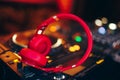 Closeup pair of Cheer red headphones for DJ.cd mp4 music deejay mixing desk music party in nightclub. Club console for experiments Royalty Free Stock Photo