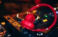 Closeup pair of Cheer red headphones for DJ.cd mp4 music deejay mixing desk music party in nightclub. Club console for experiments Royalty Free Stock Photo