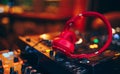 Closeup pair of Cheer red headphones for DJ.cd mp4 music deejay mixing desk music party in nightclub. Club console for experiments Royalty Free Stock Photo