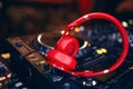 Closeup pair of Cheer red headphones for DJ.cd mp4 music deejay mixing desk music party in nightclub. Club console for experiments Royalty Free Stock Photo