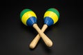 A pair of colorful maracas lying on a black underground Royalty Free Stock Photo