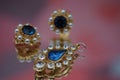 Closeup of pair of earrings with diamonds