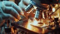 A closeup of a pair of hands expertly working with delicate microscopes and tweezers to manipulate tiny graphene