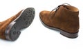 Closeup of Pair of Male Brown Suede Chukka Boots Placed Randomly Together On White Background Royalty Free Stock Photo