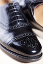 Closeup of Pair of Male Stylish Black Polished Oxford Semi-Brogu